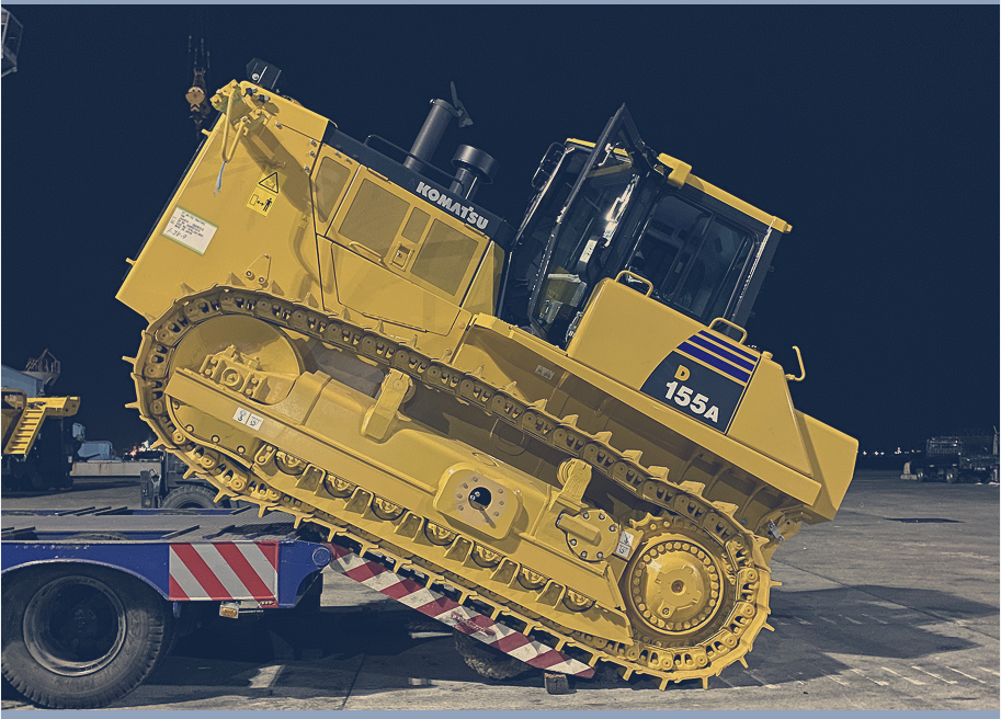 JAP stevedoring crew guiding vehicle discharge on the port